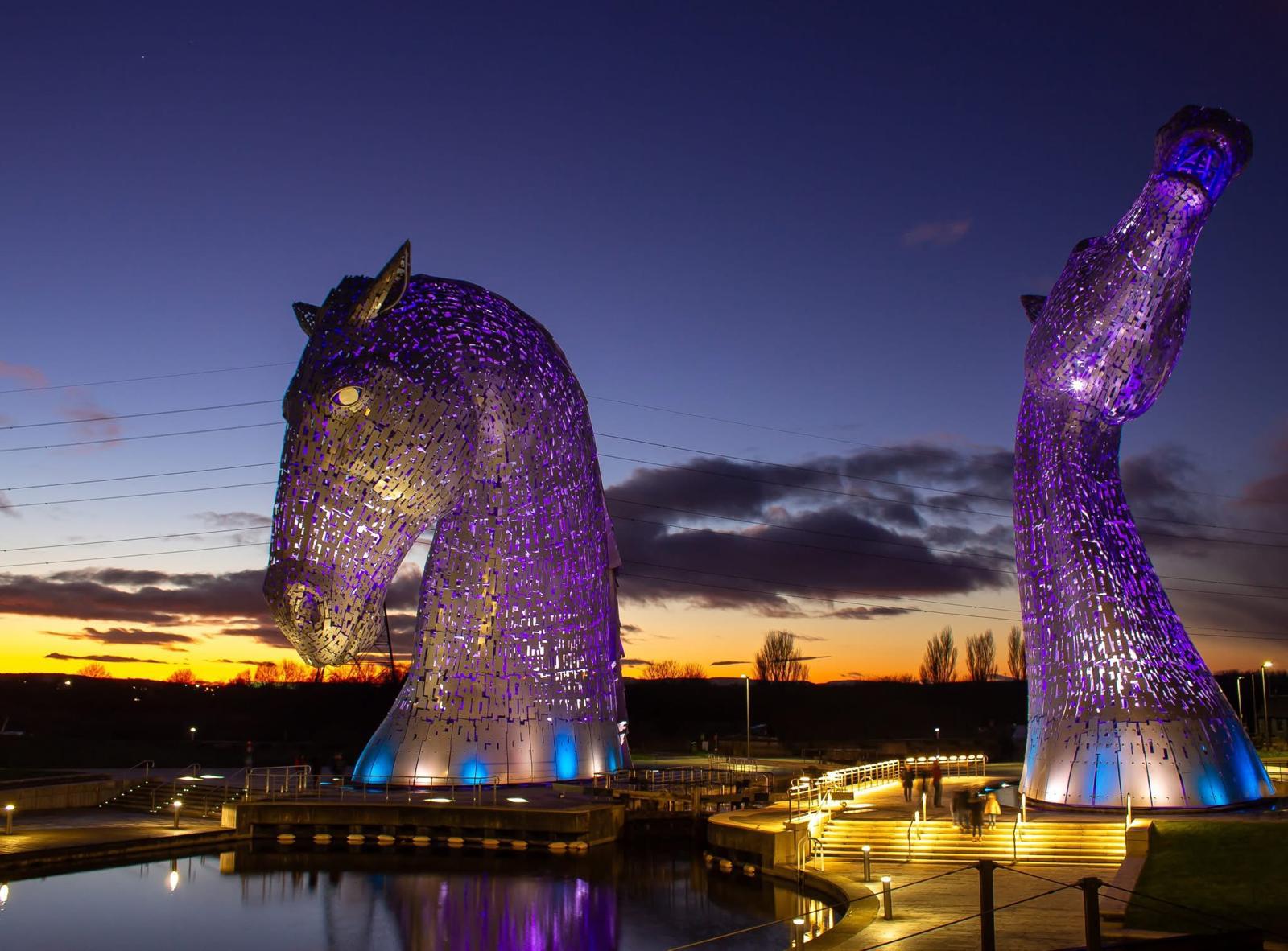 The Kelpies sculptures illuminated at sunset in Falkirk