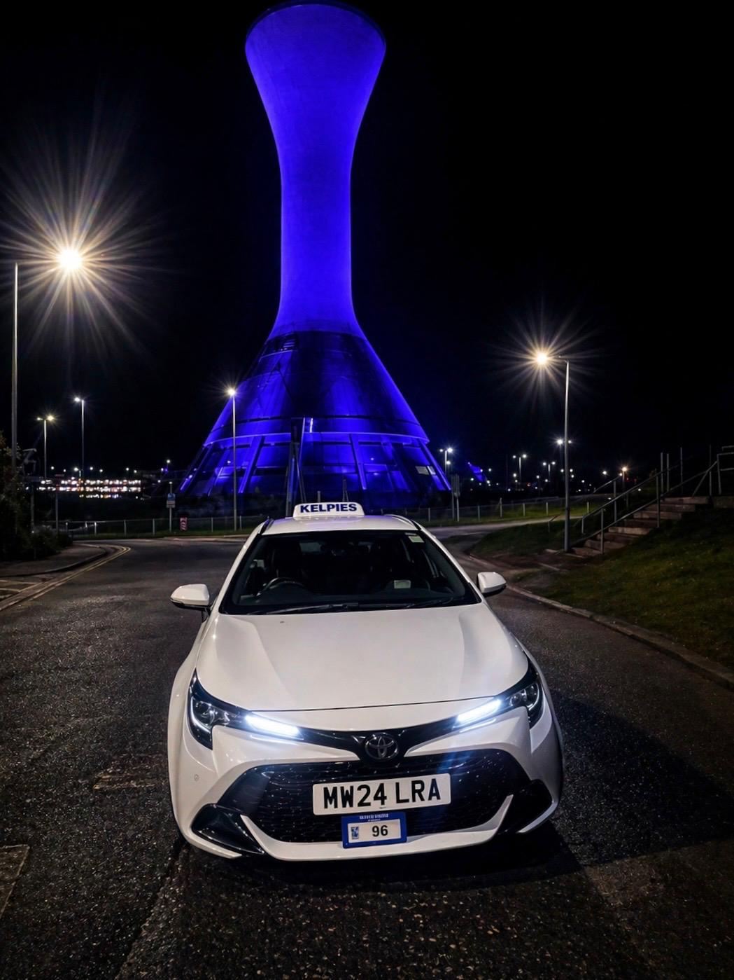 Kelpies Cabs taxi at night near Falkirk landmark